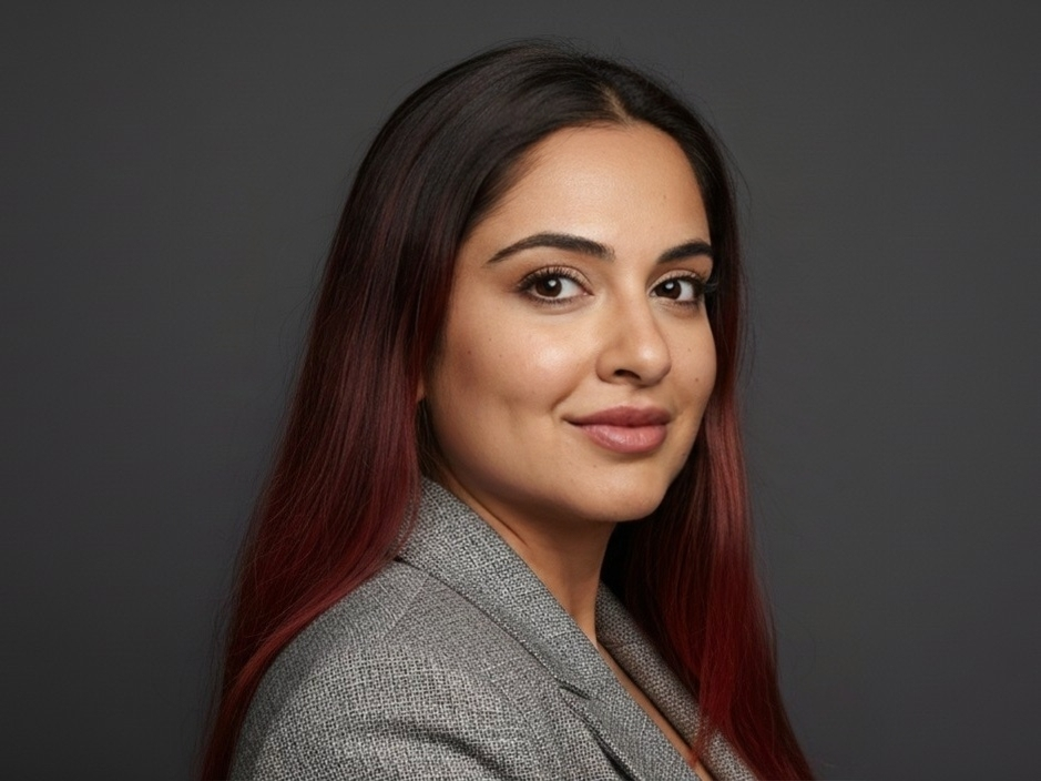 Professional headshot of Tammy Ashraf in a gray blazer